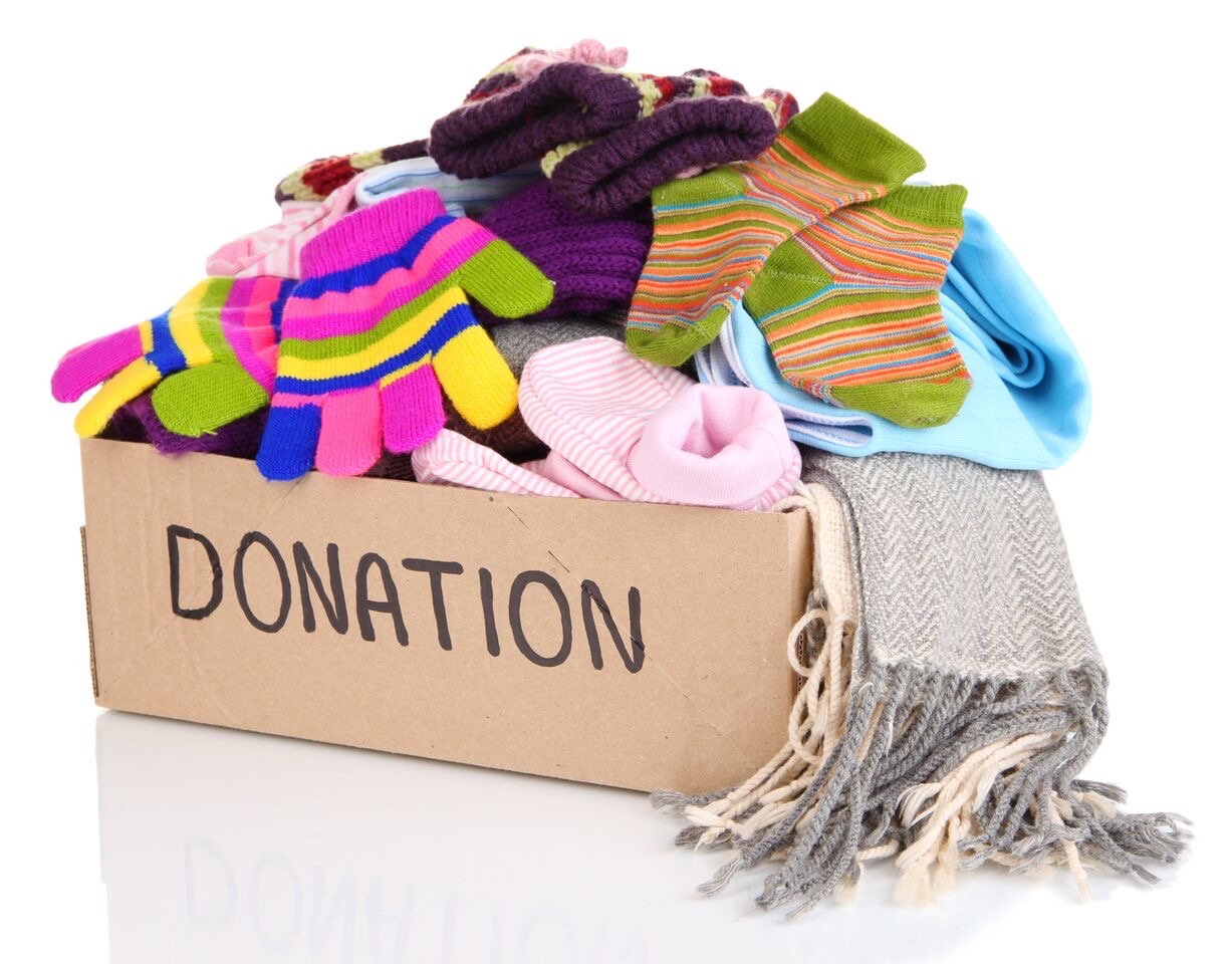 a pile of old clothes in a donation box