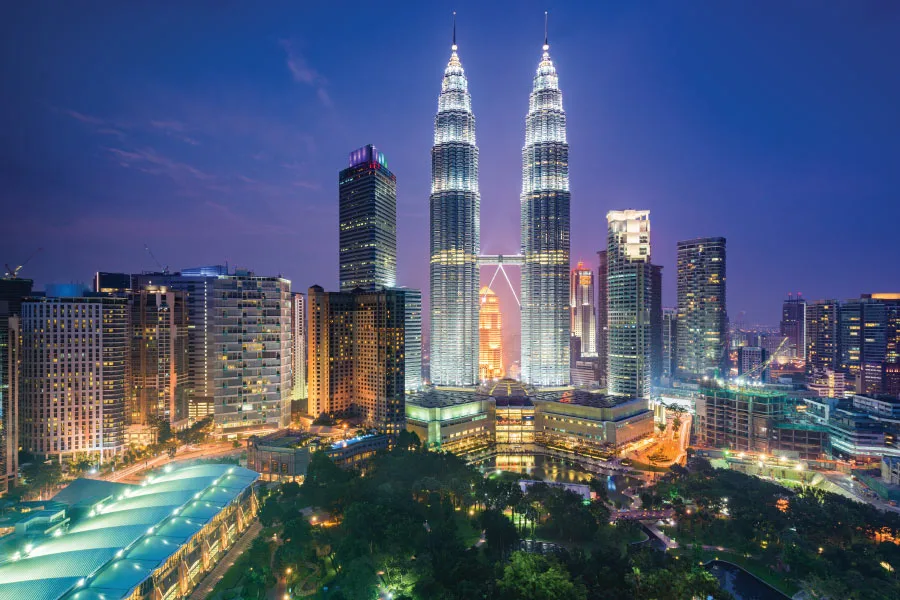 city at night with lights from skyscrapers and the tallest twin towers