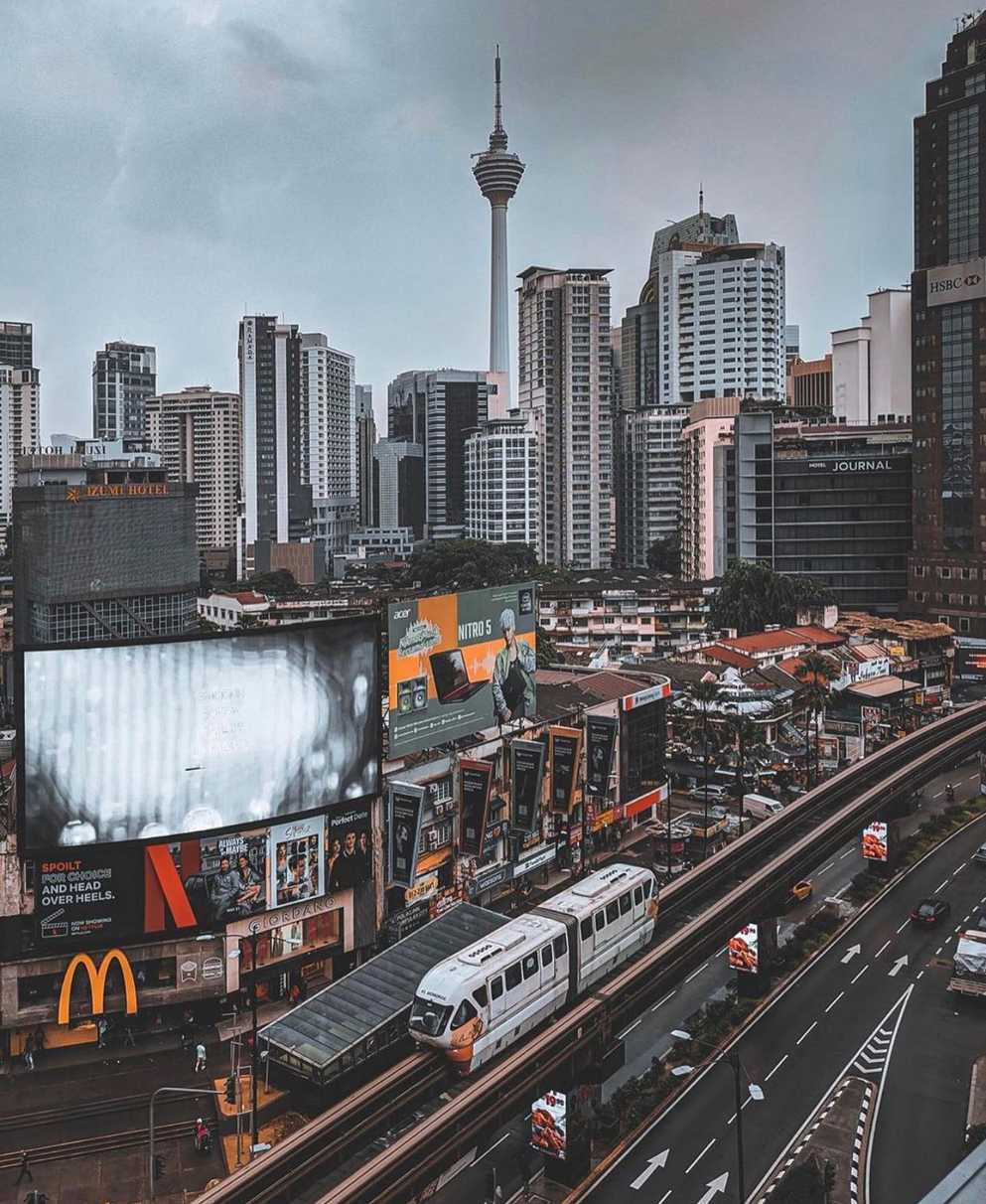 a day in Kuala Lumpur city with the Kuala Lumpur tower at the background