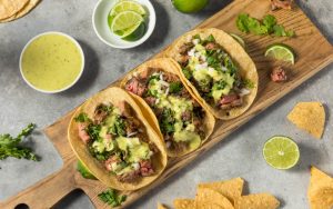 Mexican tacos served on a wooden tray