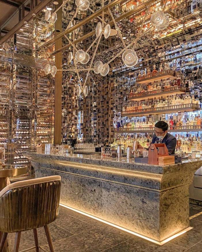 Cocktail bar counter with variety of liquor choices at the back