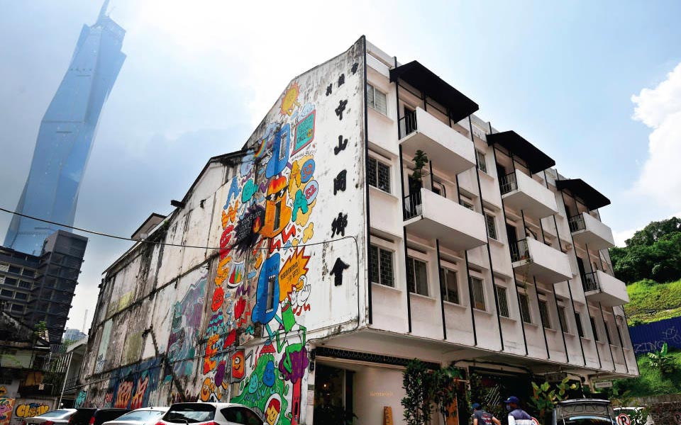 an old building painted with street art in downtown Kuala Lumpur