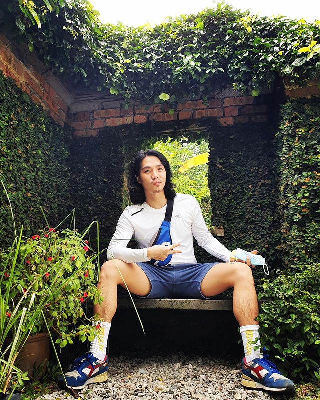 A man posing for a photoshoot at the community garden in Kuala Lumpur