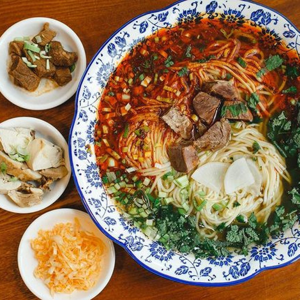 Chinese type of noodles served in a bowl with side dishes
