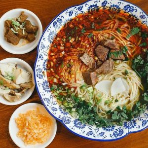 Chinese type of noodles served in a bowl with side dishes