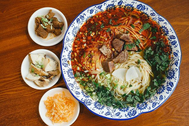 Chinese type of noodles served in a bowl with side dishes
