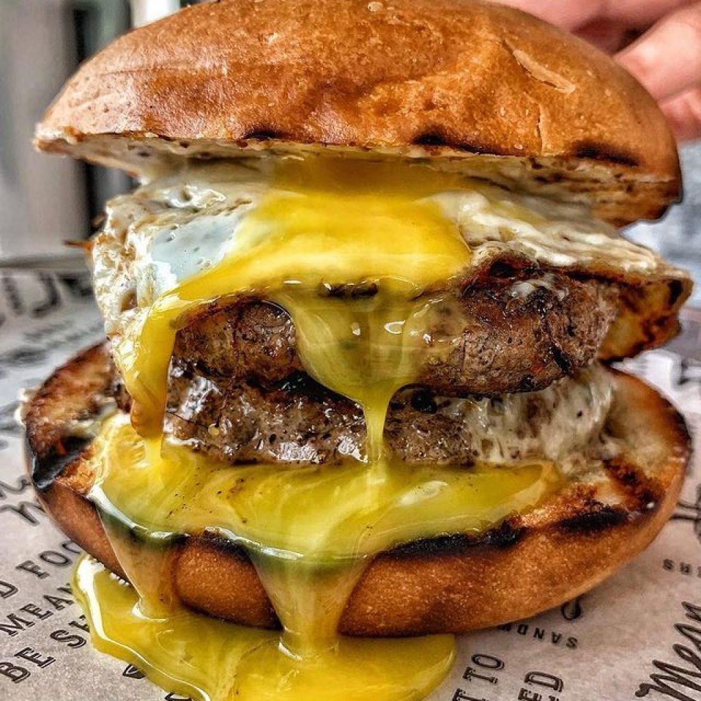burger with melted cheese flowing out