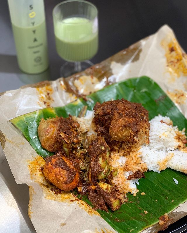 nasi lemak with curry wrapped with banana leaf and packaging