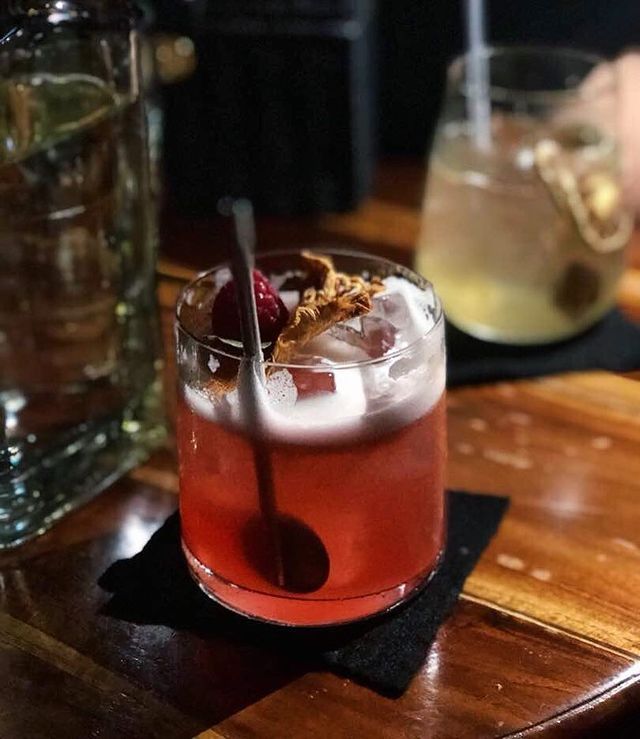 red colour cocktail served in a glass