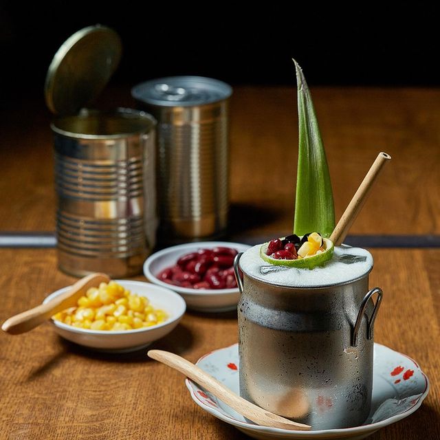 cocktail with red bean, corn and garnished with pandan leaf served in a aluminium mug 