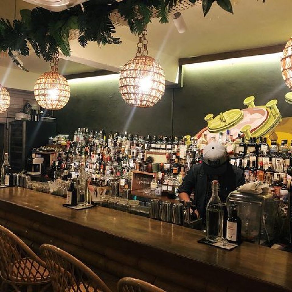 cocktail bar with a background of different liquors and ingredients