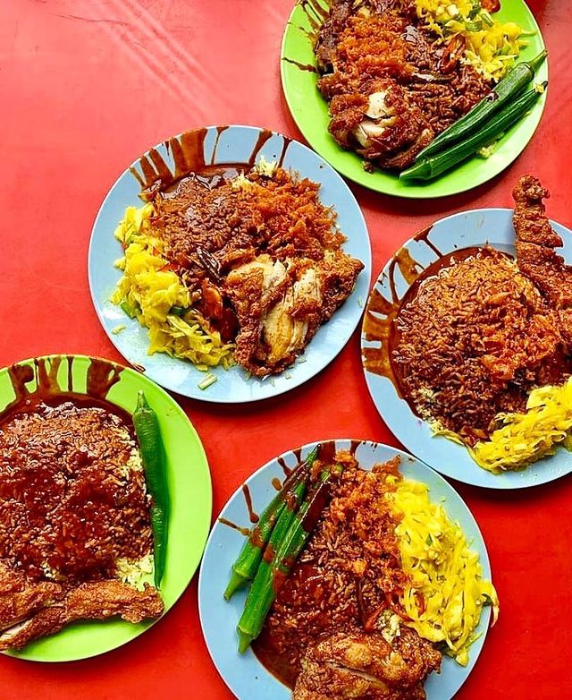 plates of rice served with fried chicken, cabbages and okra