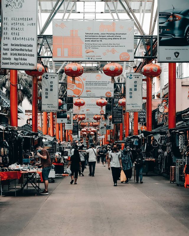 people walking streets with street traders on both sides