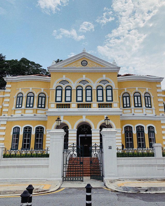 the facade of an old yellow heritage mansion in Kuala Lumpur