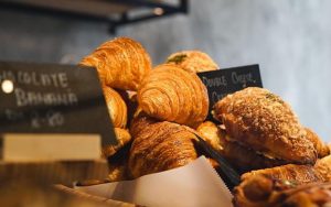 a pile of different type of croissants for sale