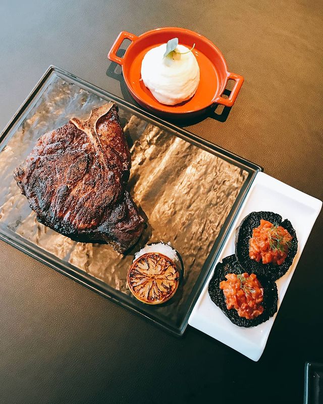 grilled T-bone steak served with side dishes