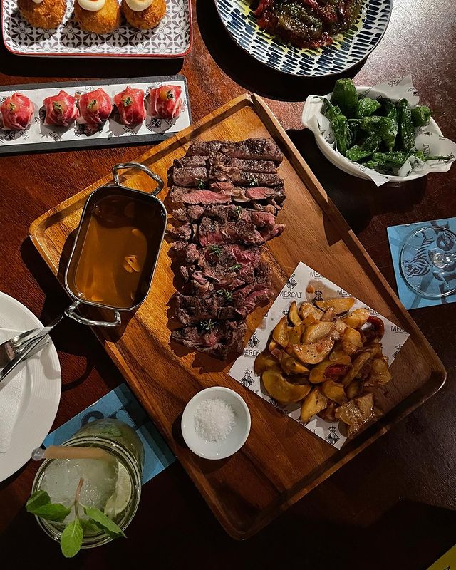 slices of grilled steak served on a wooden board