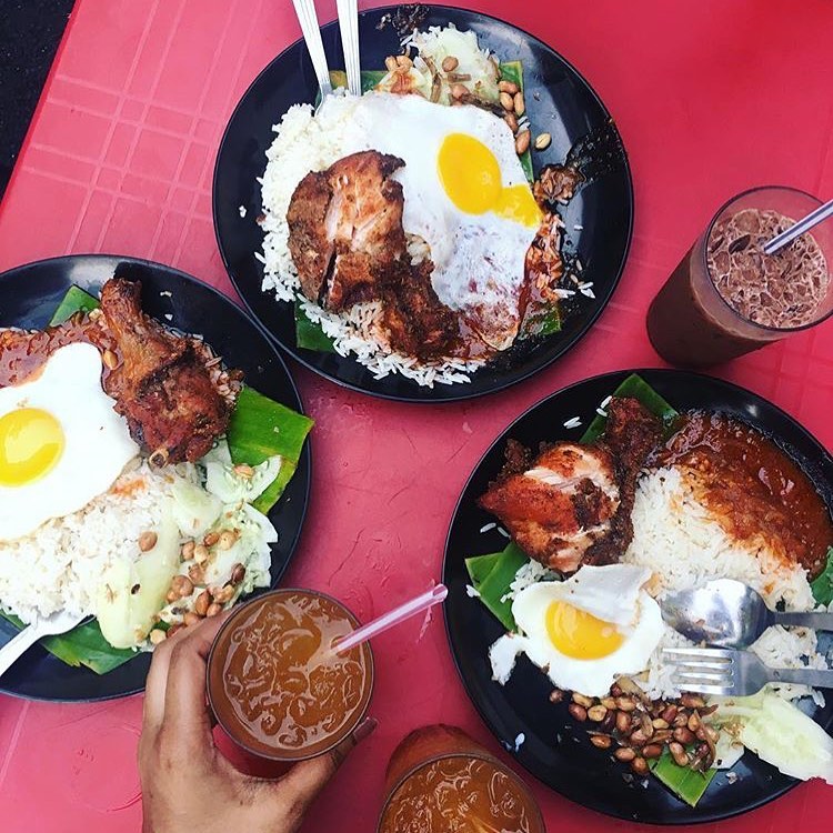 places of rice served with fried chicken, fried egg, peanuts, anchovies and sambal
