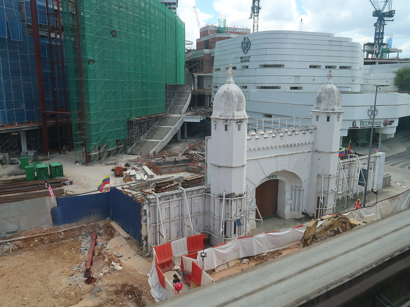 an old gate preserved while new developments are being built at the back