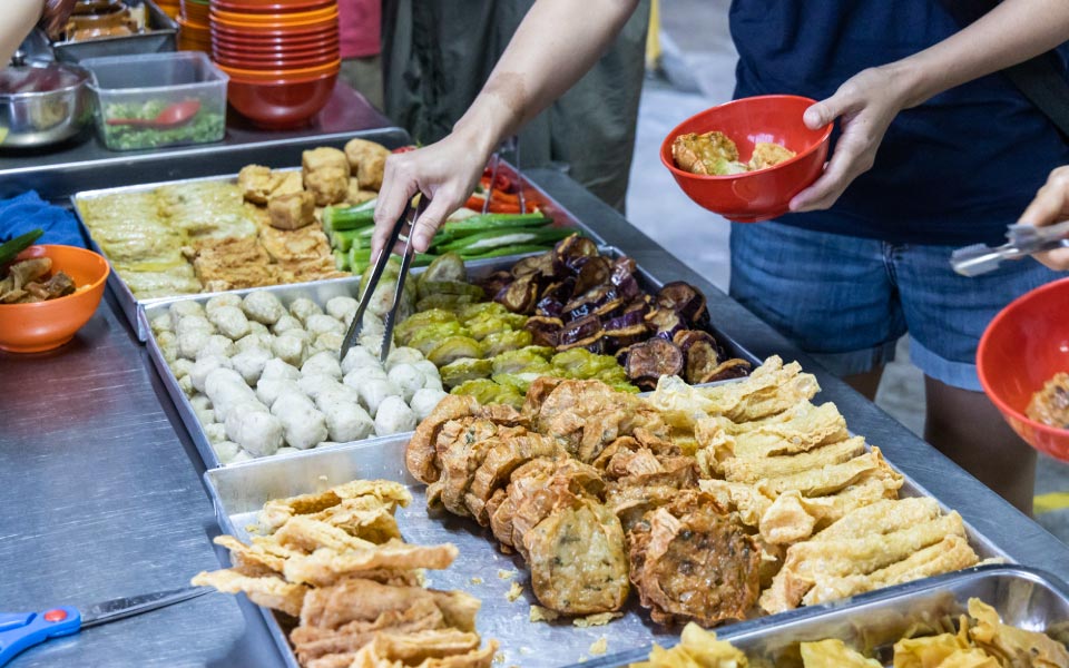a person picking dishes displayed on a countertop