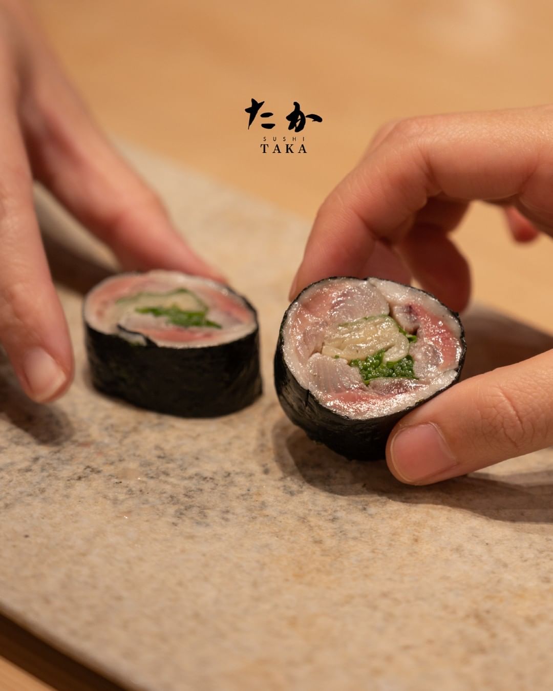 hand holdings sushi