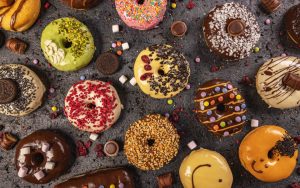 different doughnuts dipped and glazed with different flavours and sauces