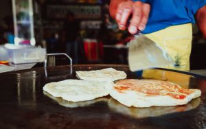 hand cooking roti canai
