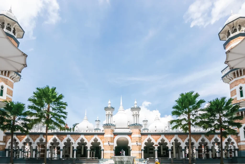 architecture of mosque with palms surrounding it