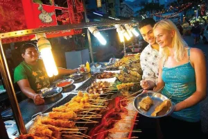 couple choosing foods from a street stall