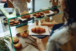 cafe service crew taking croissant getting it ready to serve