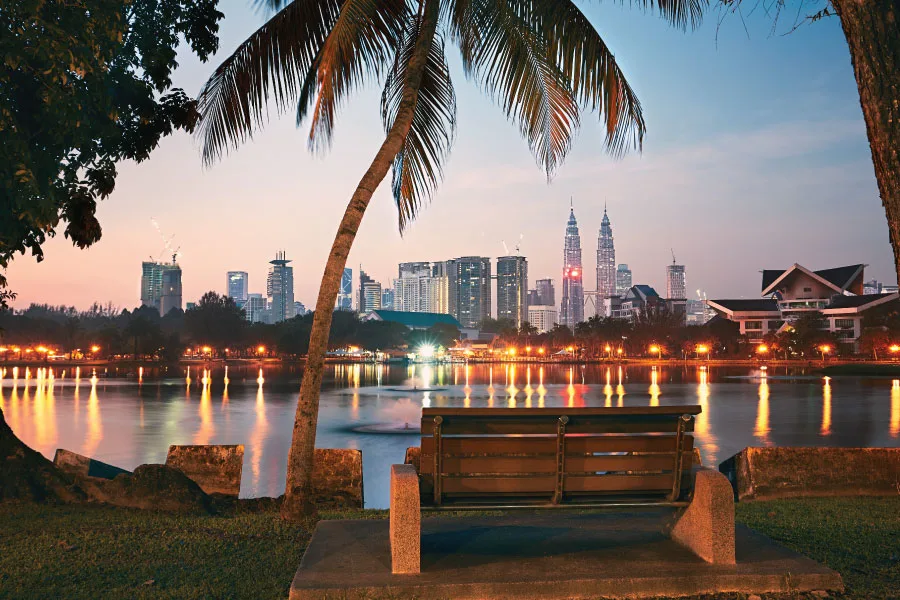bench by a lake with a view of the city's skyline