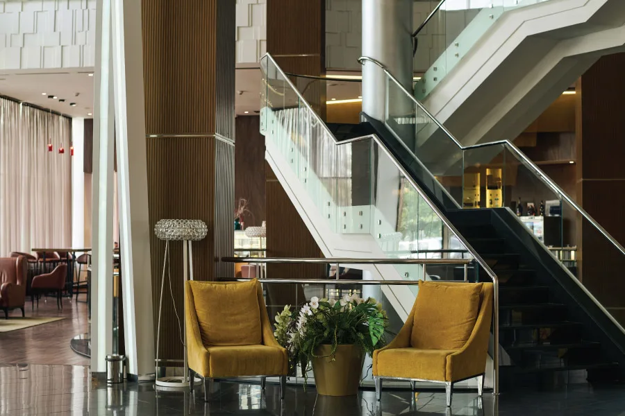 sofa, coffee tables in a lobby with a staircase