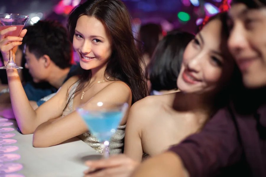 stylish young people at a bar counter