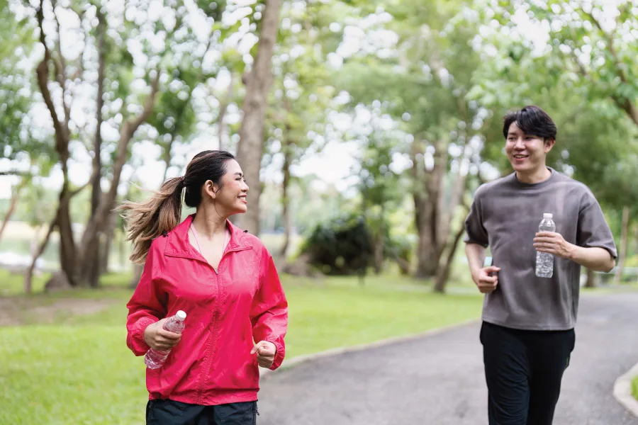 a young couple jogging in a park