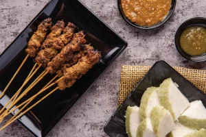meat on skewers served on a plate
