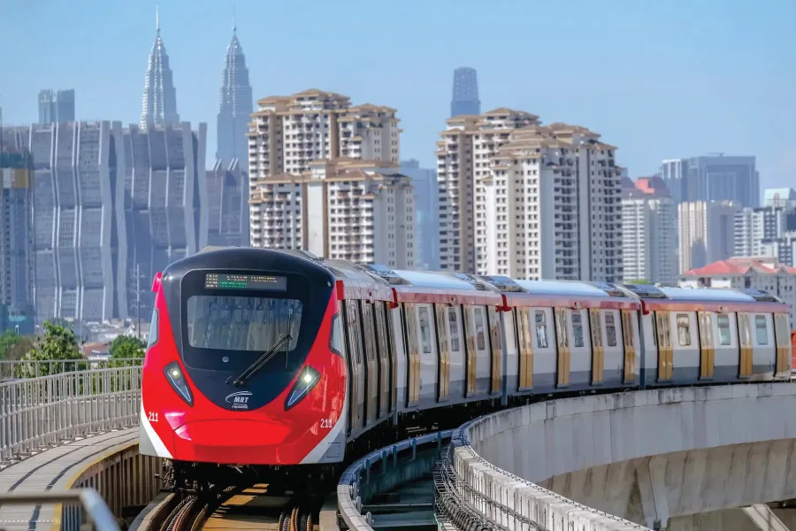 train on the tracks with the city skyline at the back