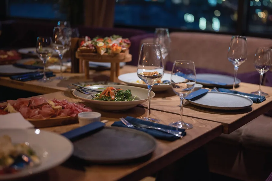 meals served on a table with cutleries, plates, glasses