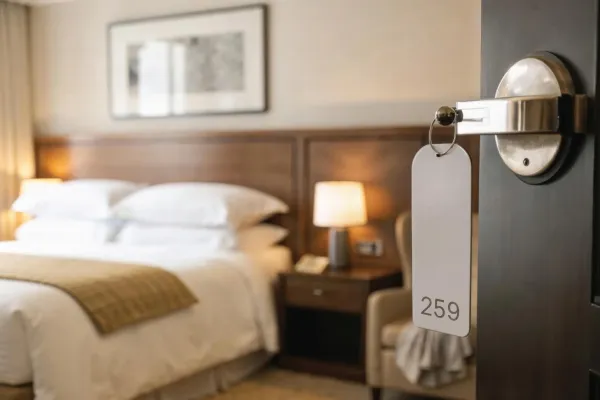 door of a hotel room opened overlooking the bed