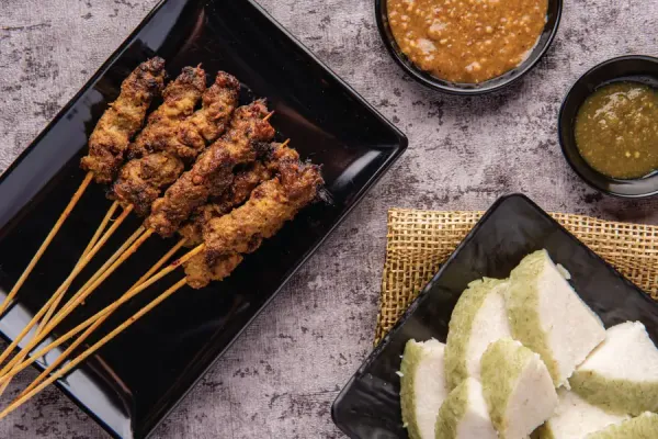 meat on skewers served on a plate